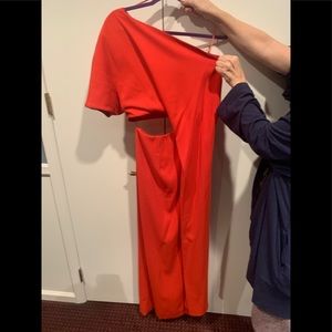 Solace, one-sleeve, red gown with side cutout.